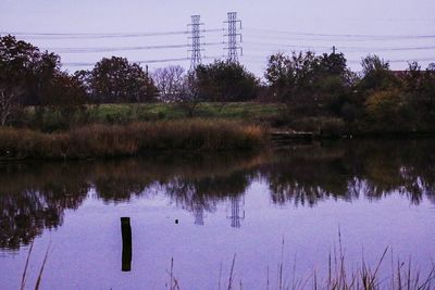 Reflection of trees in lake against sky