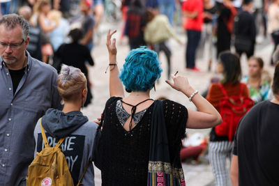 Rear view of people standing on street