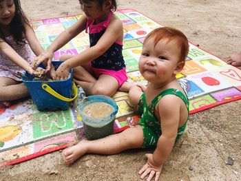 Children playing with sand at beach