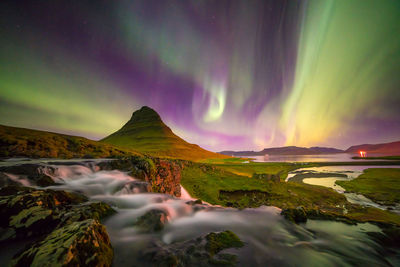 Scenic view of landscape against sky at night