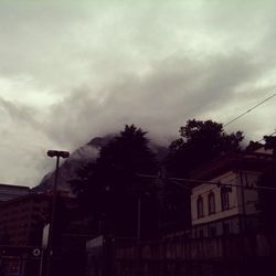 Low angle view of building against cloudy sky