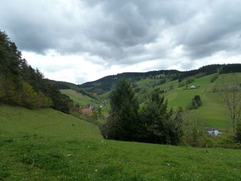 Scenic view of field and mountains against sky