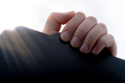 Close-up of hands over white background