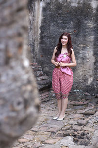 Portrait of a smiling young woman standing outdoors