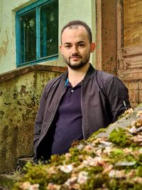 Portrait of young man standing outdoors