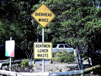 Close-up of road sign against trees