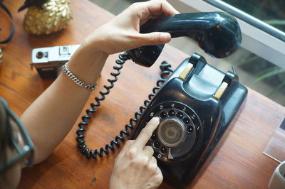 High angle view of person using smart phone on table