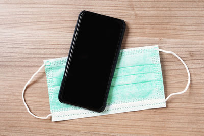 High angle view of smart phone on table