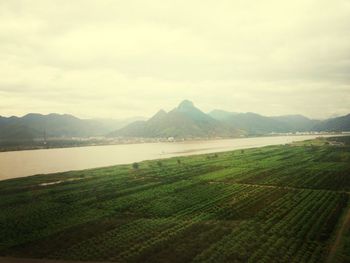 Scenic view of lake against cloudy sky