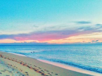 Scenic view of beach against sky during sunset