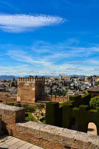 Buildings in city against blue sky