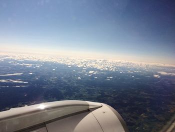 Airplane flying over sea against sky