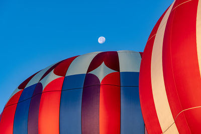 Low angle view of hot air balloon against blue sky