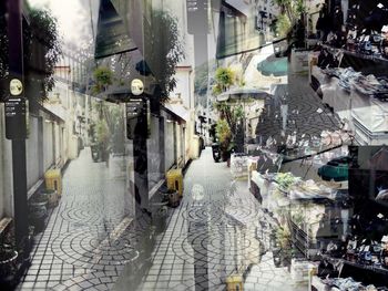 Digital composite image of street amidst buildings in city