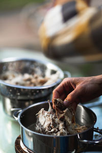 Midsection of man preparing food in container