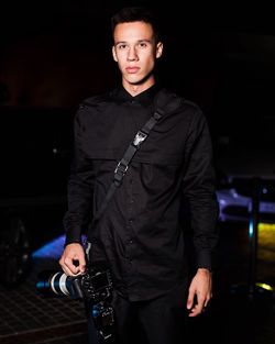 Portrait of handsome photographer at night