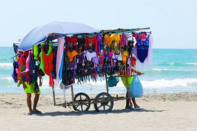 Multi colored umbrellas on beach against sea