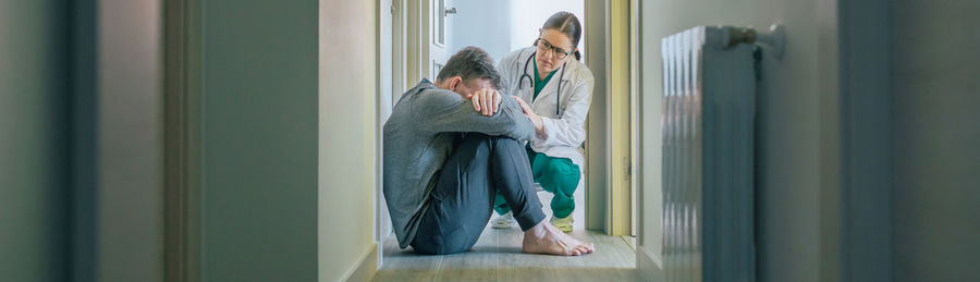 Doctor assisting and comforting to patient with mental disorder and suicidal thoughts