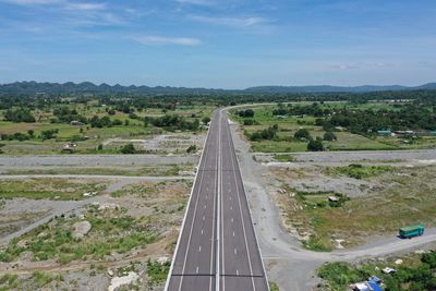 High angle view of road amidst trees against sky