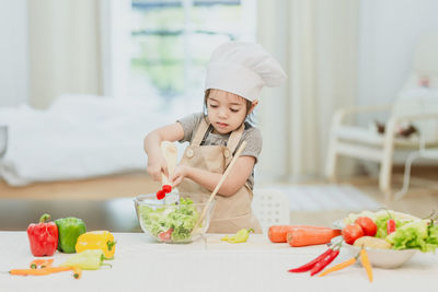 Girl holding food on table