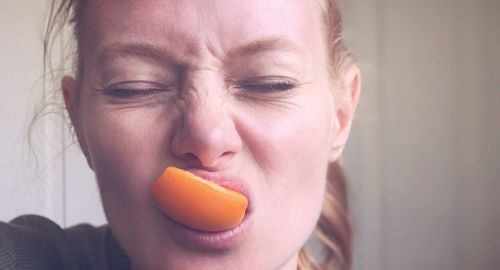 Close-up portrait of man eating fruit