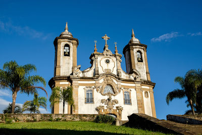 Low angle view of historical building against blue sky