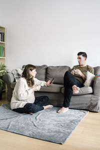 People sitting on sofa at home