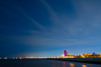 Illuminated building against sky at night