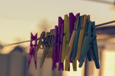 Close-up of clothespins hanging on clothesline