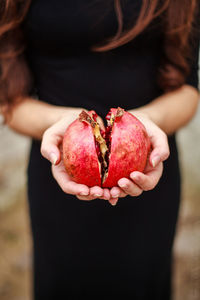 Close-up of woman holding pomegranate