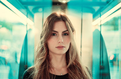 Close-up portrait of beautiful young woman in vehicle