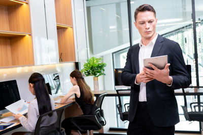 Portrait of businessman using mobile phone