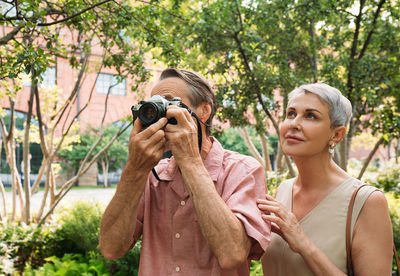 Side view of man photographing through camera