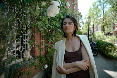 Portrait of woman standing against plants