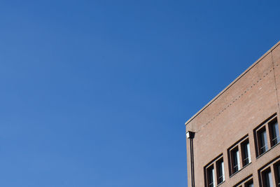 Low angle view of building against blue sky