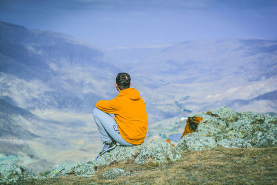 Rear view of person with umbrella on mountain