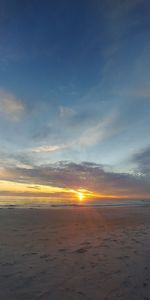 Scenic view of beach against sky during sunset