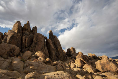 Low angle view of rock formation against sky