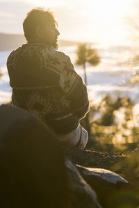 Rear view of woman looking at sea against sky