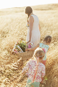 Mother with daughters in meadow