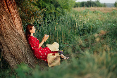 Self-care ideas list. activities to add to self-care plan. woman in red dress with open notepad on