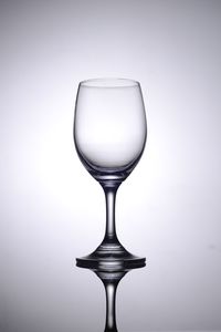 Close-up of wineglass against white background