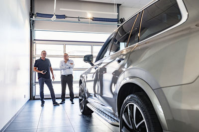 Men in car showroom