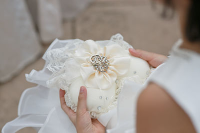 Midsection of bride holding wedding rings