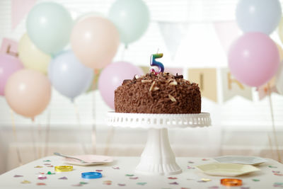 Birthday cake with 5 sign candle sit on the table for 5 years old young girl