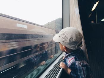 Boy looking through train window