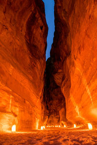 The siq canyon illuminated by candles at night. petra, jordan