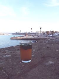 Close-up of beer in water against sky