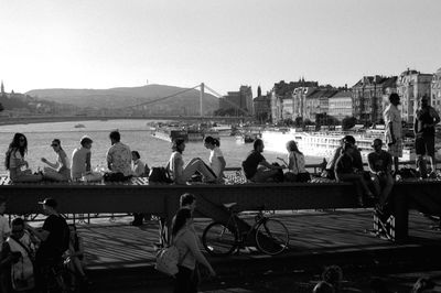 People on shore against clear sky