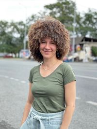 Portrait of a smiling young woman in papakha - fur hat